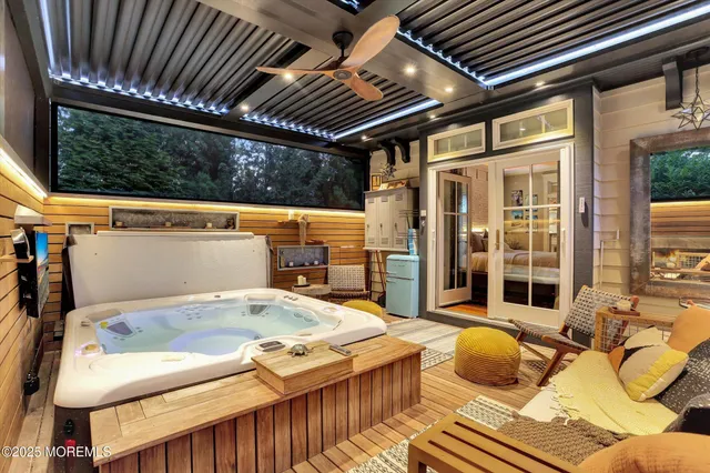 an aerial view of a house with outdoor space and trees all around