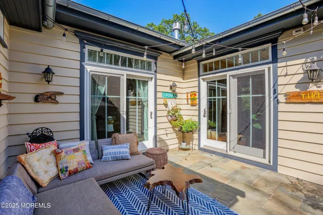 an aerial view of a house with outdoor space and trees all around