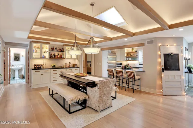 a kitchen with stainless steel appliances granite countertop a stove and white cabinets