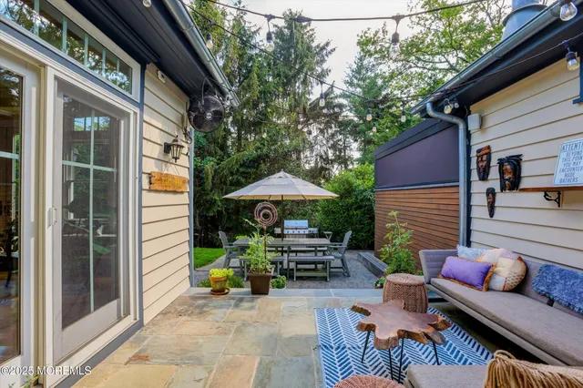 an aerial view of residential houses with outdoor space and trees