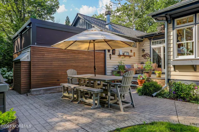 an aerial view of residential houses with outdoor space and trees all around