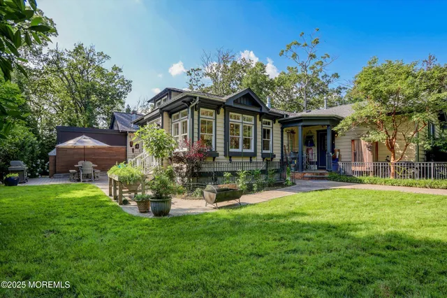 an aerial view of a house with a yard and trees