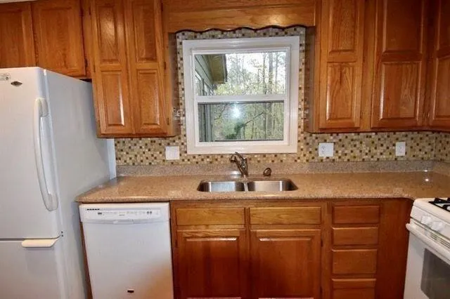 a kitchen with a sink cabinets and a refrigerator