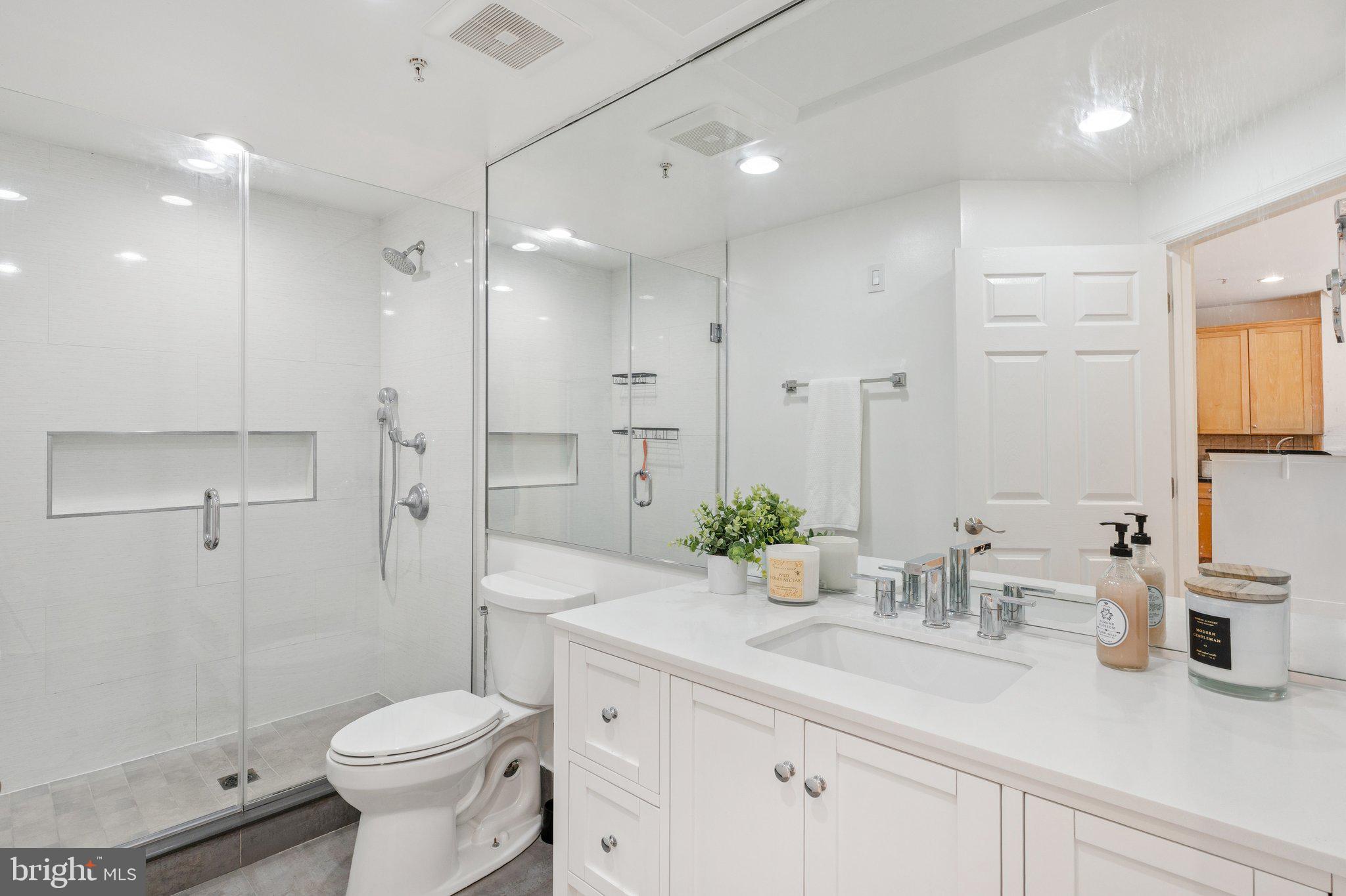 11800 Old Georgetown Road, Unit 1120 North Bethesda, MD 20852 - Photo 16 of 36 a bathroom with a granite countertop sink a toilet and shower