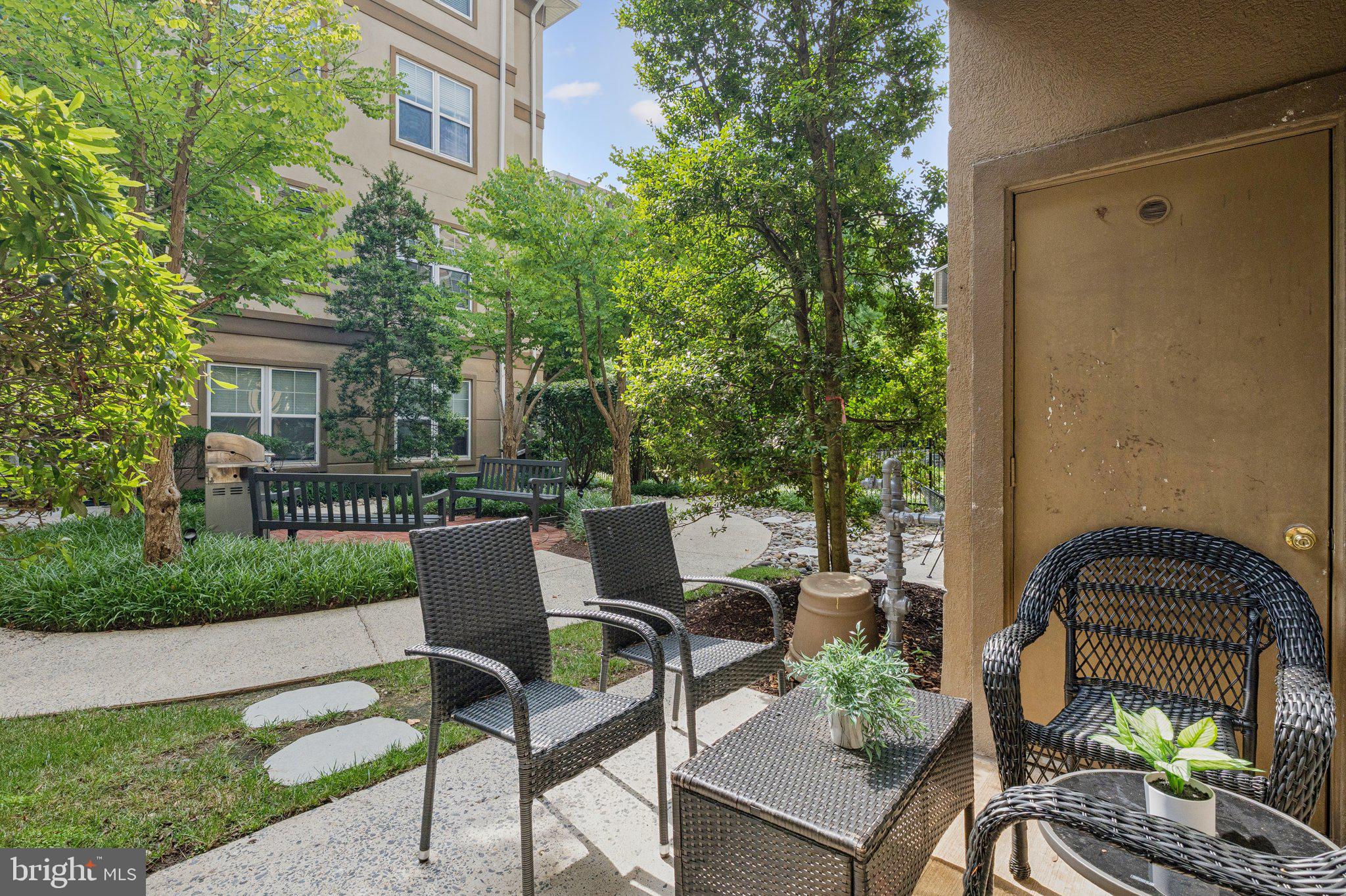 11800 Old Georgetown Road, Unit 1120 North Bethesda, MD 20852 - Photo 20 of 36 a view of a patio with table and chairs and potted plants