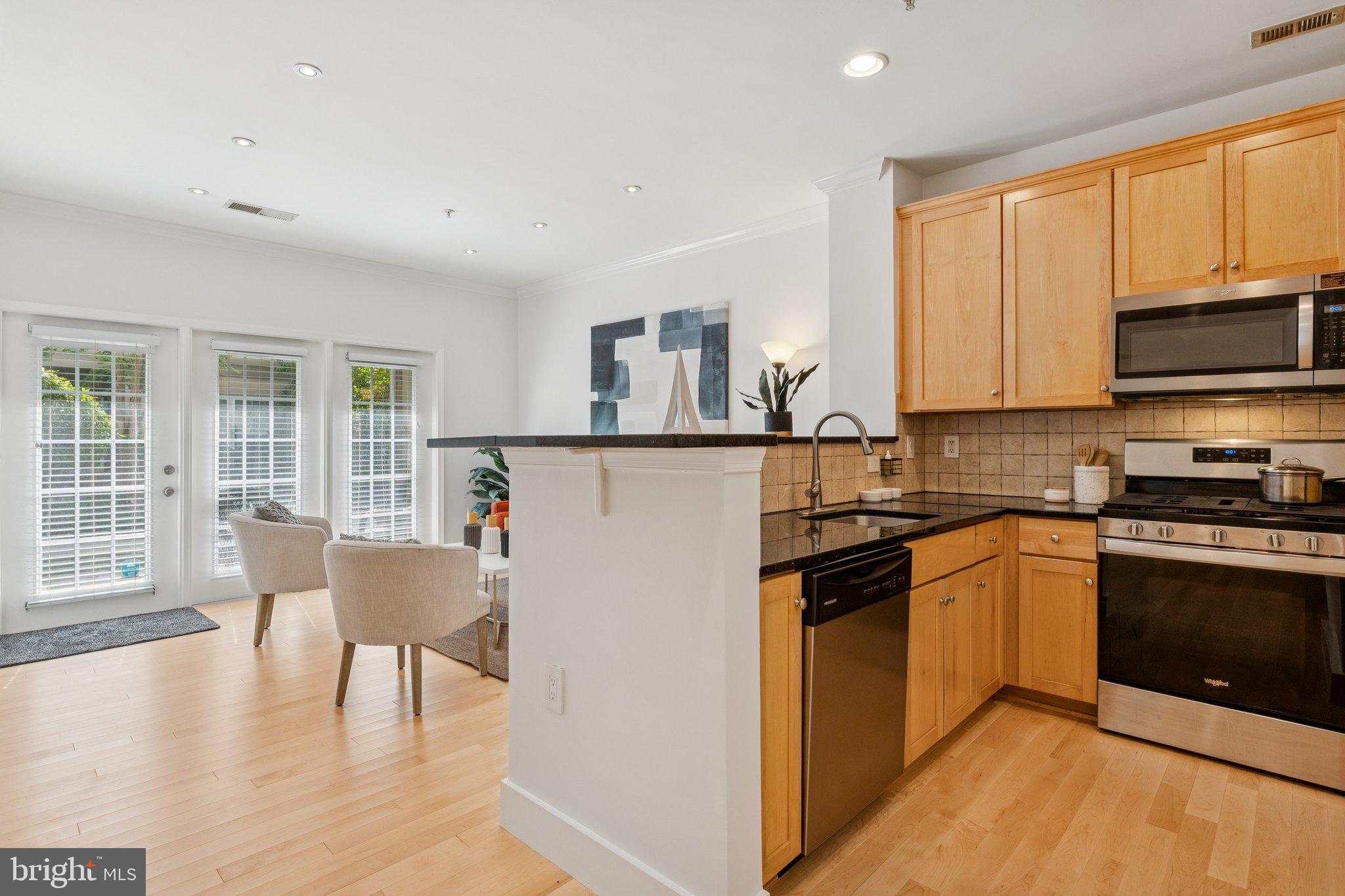 11800 Old Georgetown Road, Unit 1120 North Bethesda, MD 20852 - Photo 7 of 36 a kitchen with stainless steel appliances granite countertop a stove top oven a sink dishwasher and a refrigerator