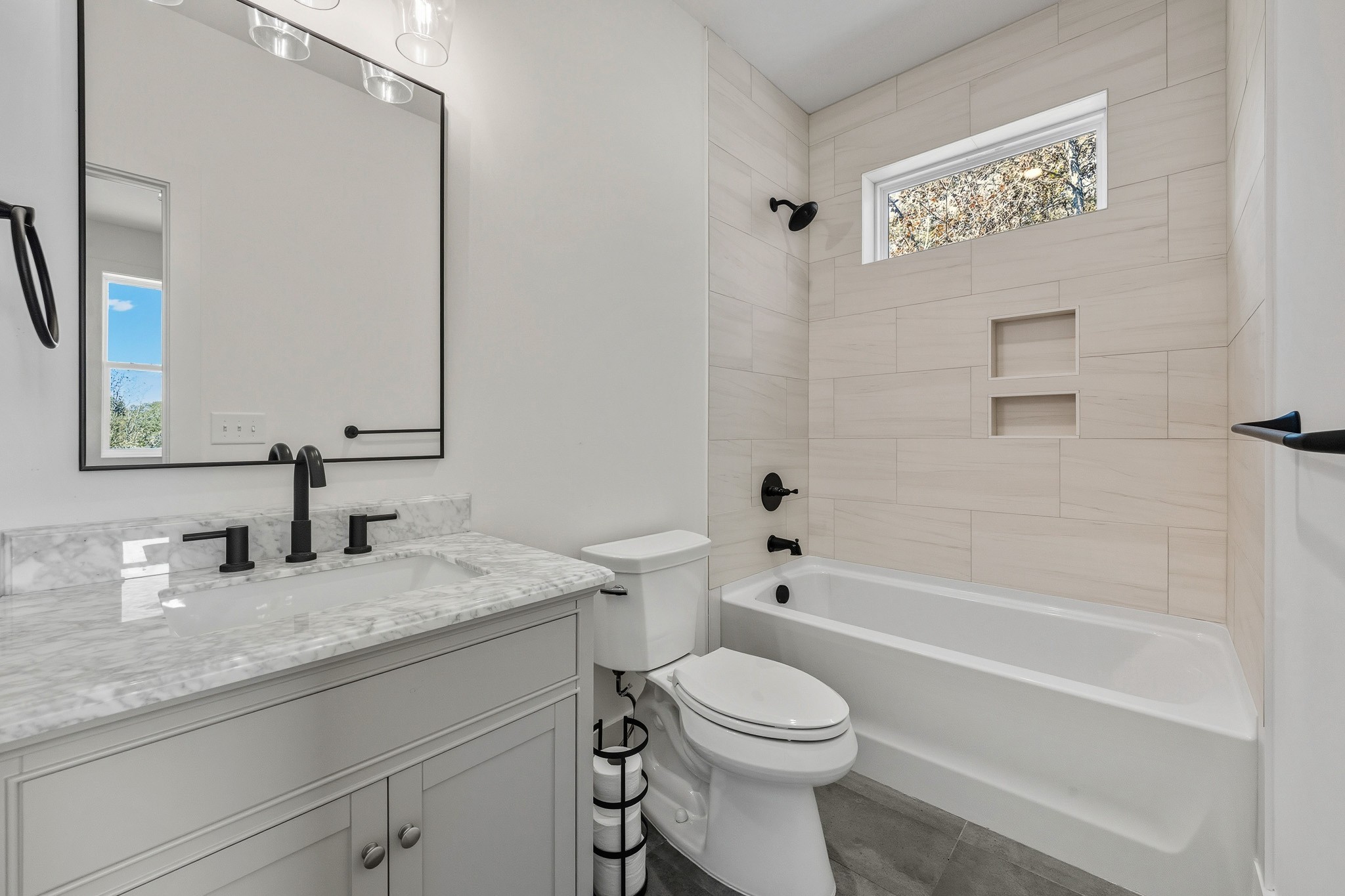 294 Rio Vista Drive Madison, TN 37115 - Photo 41 of 69 a bathroom with a granite countertop toilet a sink and a bathtub
