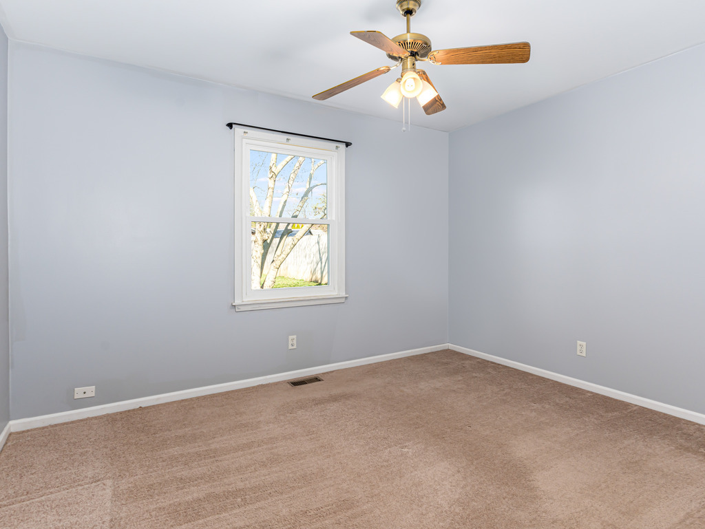 78 Springdale Road Montgomery, IL 60538 - Photo 11 of 21 an empty room with a window and a fan
