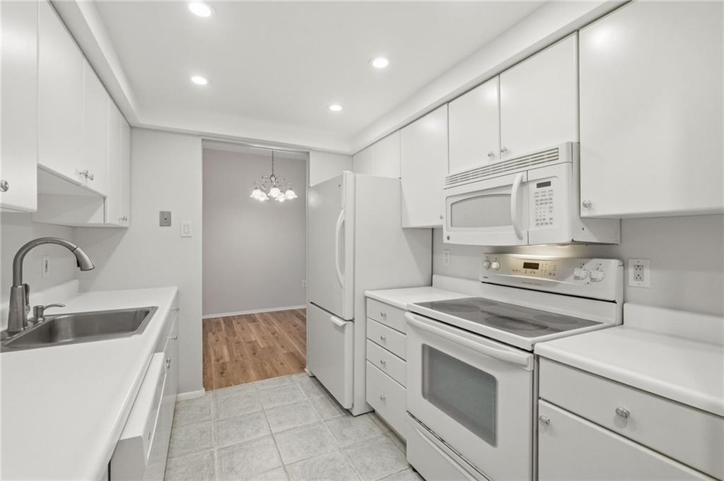5600 Munhall Road, Unit 202 Pittsburgh, PA 15217 - Photo 7 of 24 a kitchen with white cabinets and white appliances