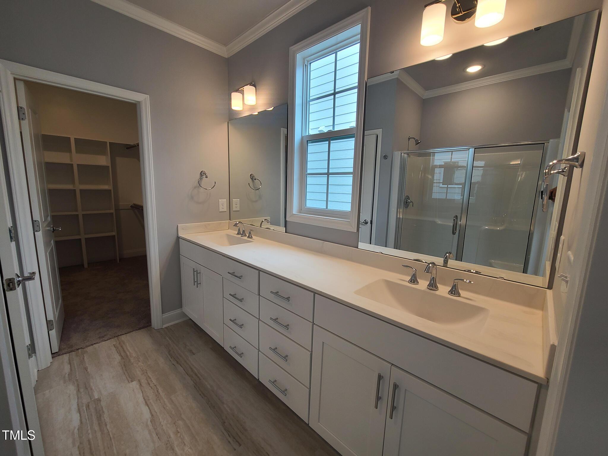 1629 Glazebrook Drive Wake Forest, NC 27587 - Photo 15 of 35 a bathroom with double vanity sink a vanity and a large mirror