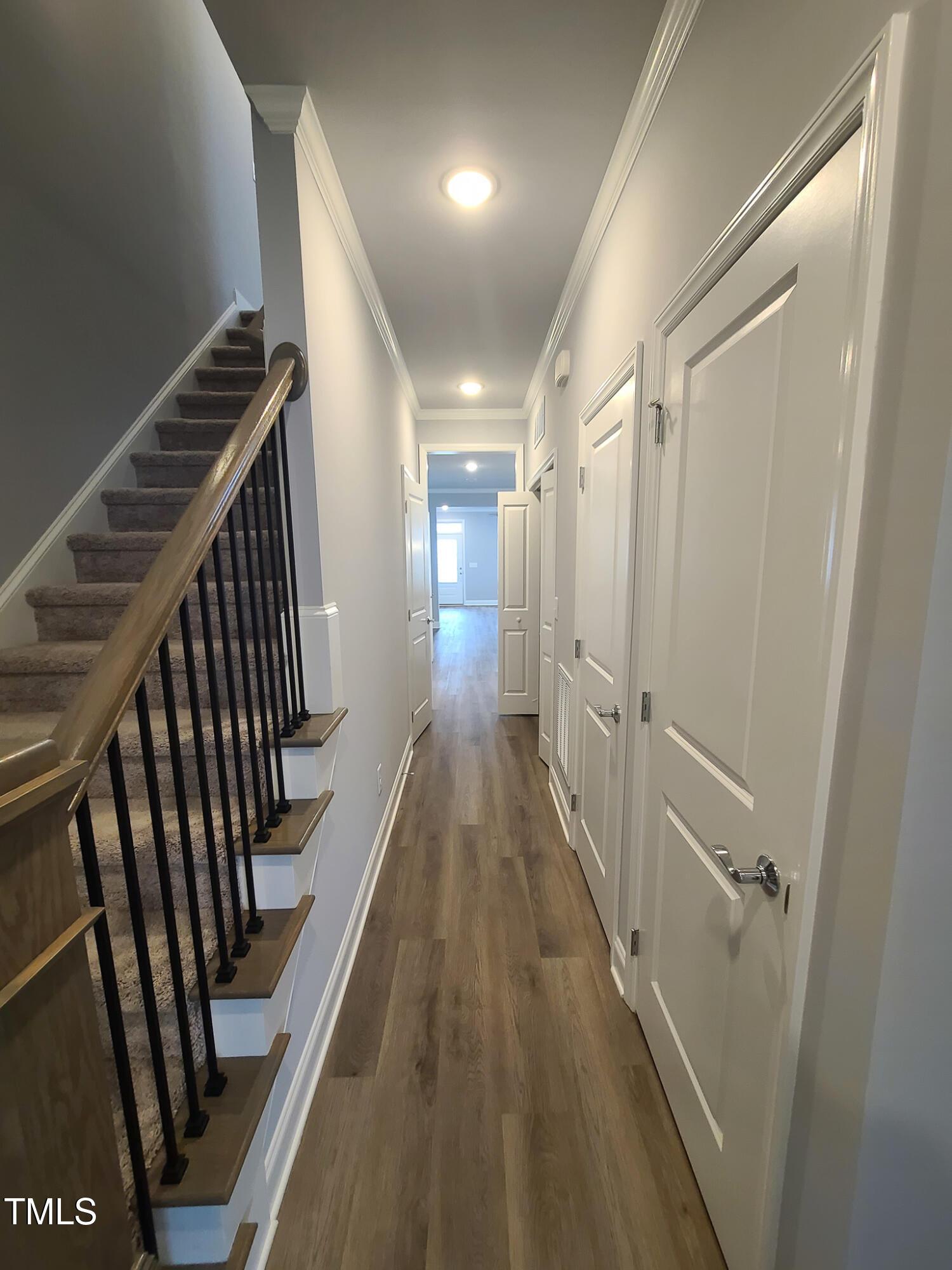 1629 Glazebrook Drive Wake Forest, NC 27587 - Photo 20 of 35 a view of a hallway with wooden floor and stairs