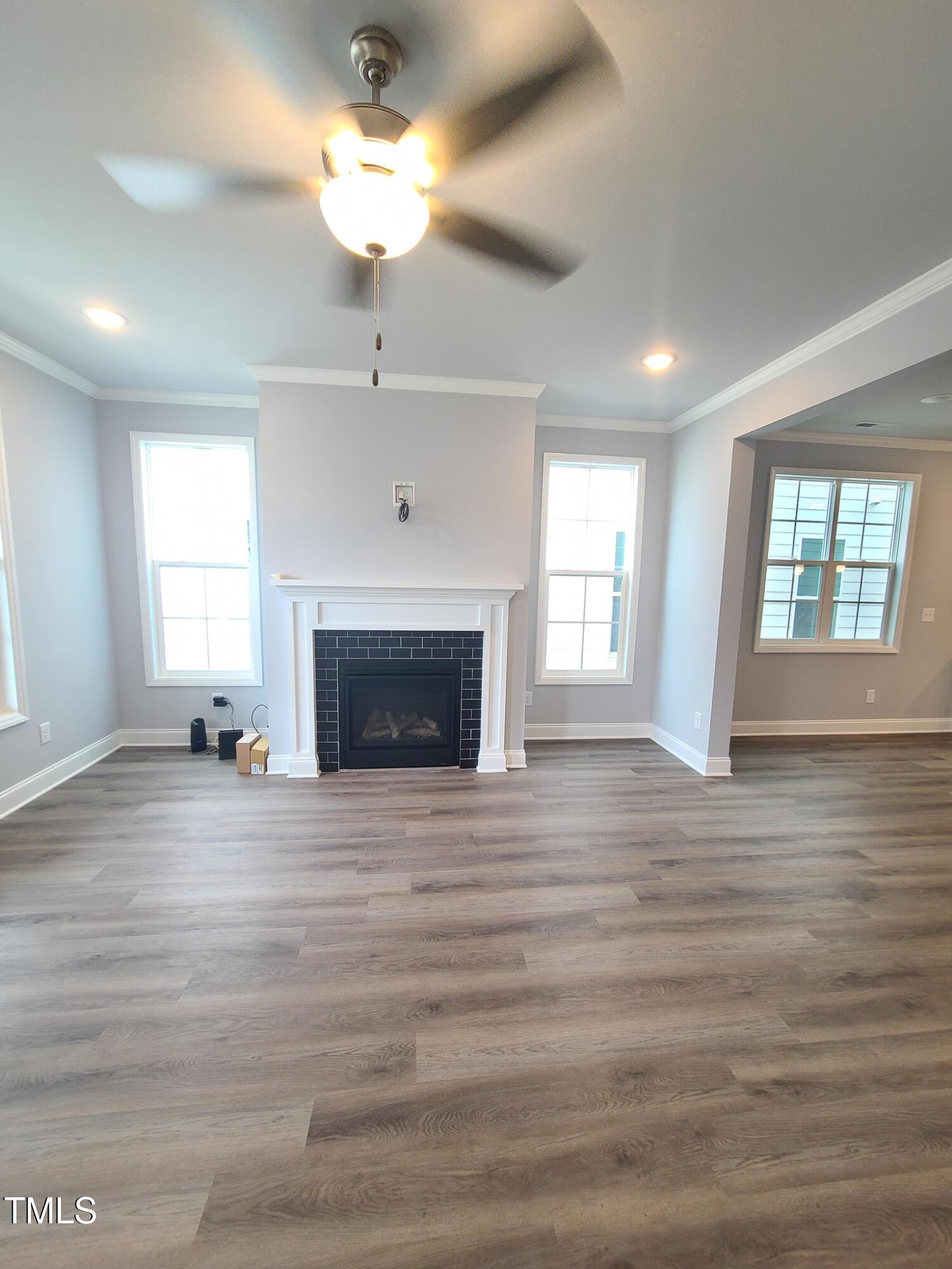 1629 Glazebrook Drive Wake Forest, NC 27587 - Photo 2 of 35 a view of an empty room with a window and fireplace