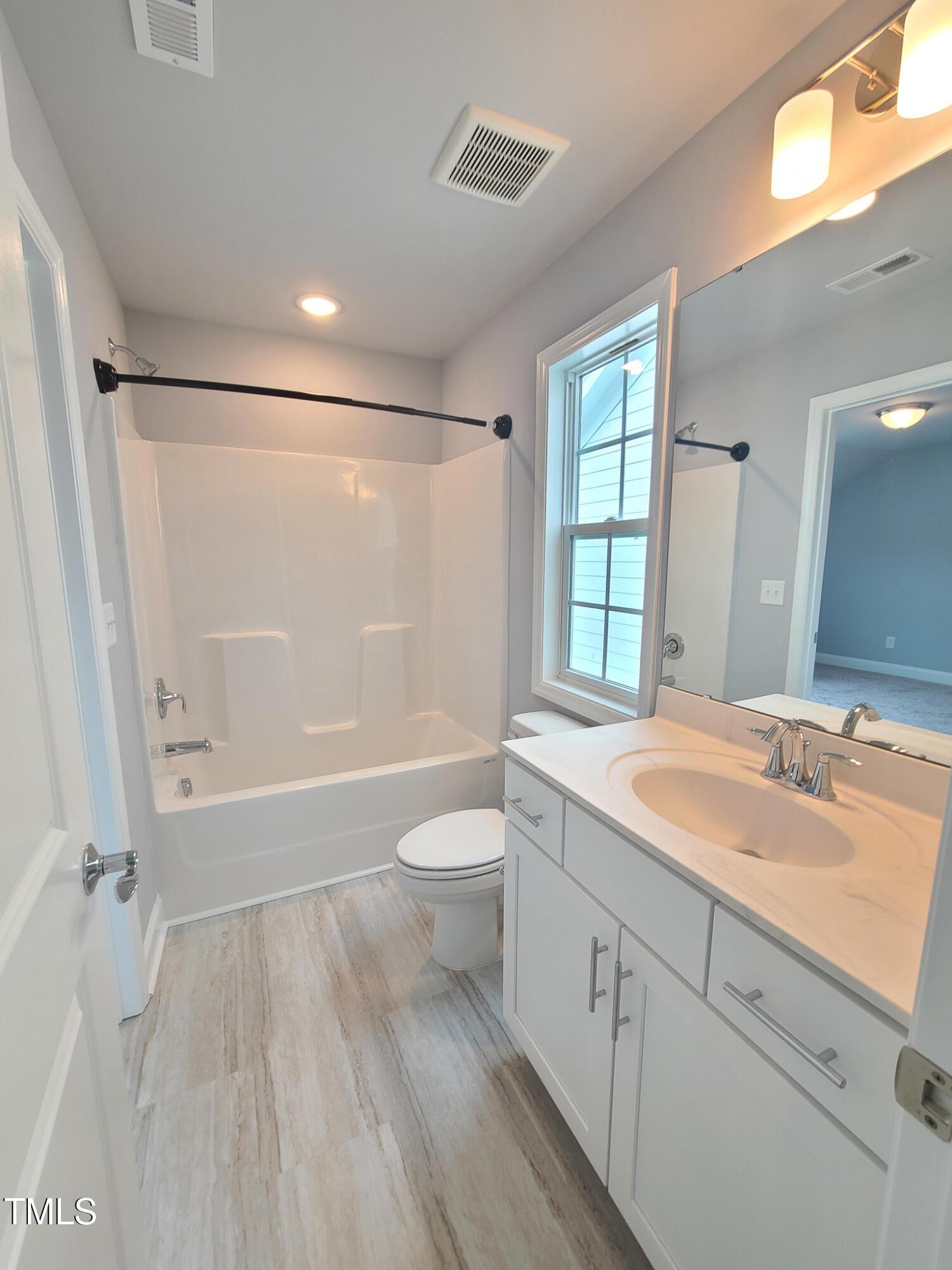 1629 Glazebrook Drive Wake Forest, NC 27587 - Photo 24 of 35 a bathroom with a granite countertop sink toilet and shower