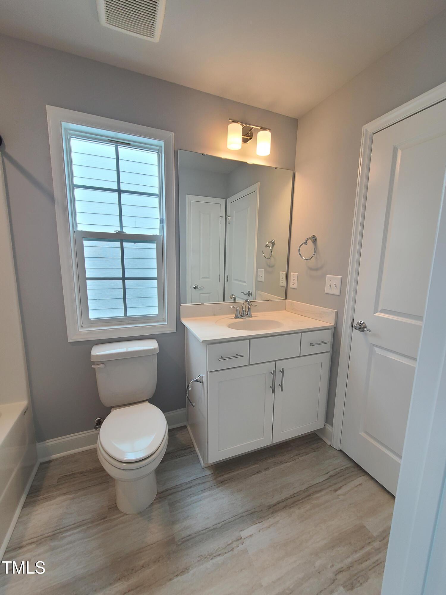 1629 Glazebrook Drive Wake Forest, NC 27587 - Photo 27 of 35 a bathroom with a toilet sink and mirror