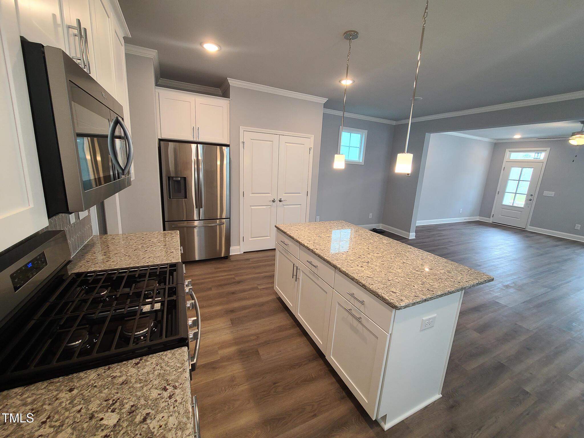1629 Glazebrook Drive Wake Forest, NC 27587 - Photo 7 of 35 a kitchen with stainless steel appliances granite countertop a stove a refrigerator and a sink
