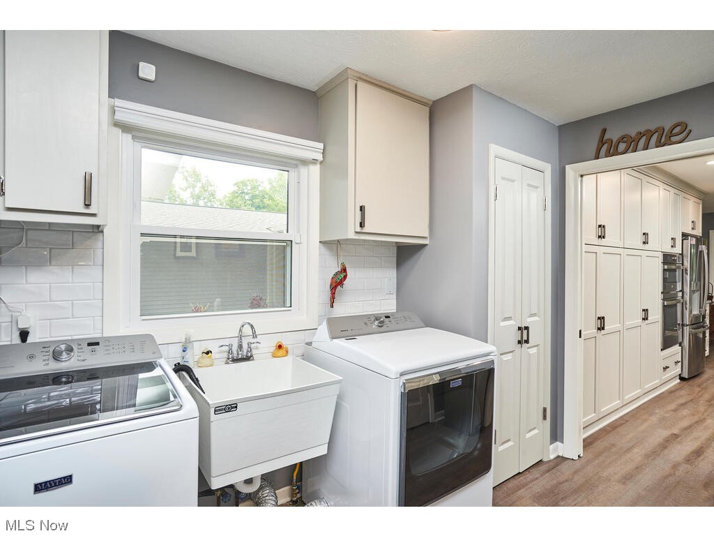 5535 River Styx Road Medina, OH 44256 - Photo 13 of 27 Laundry room with washing machine and clothes dryer and luxury vinyl flooring