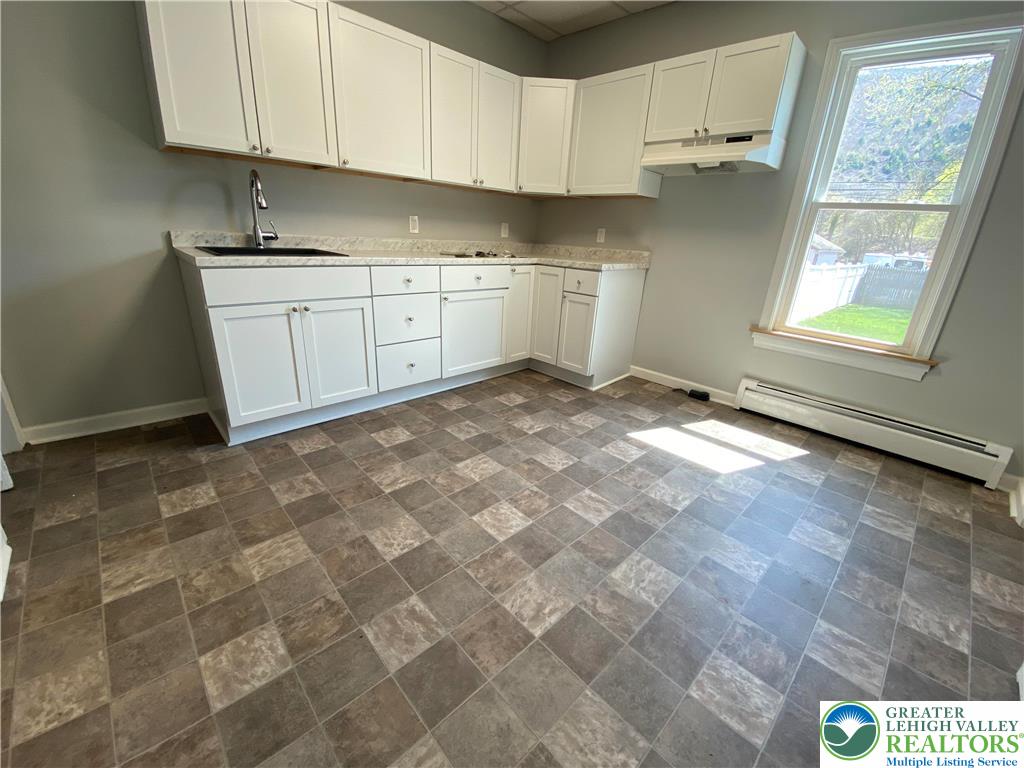 350 Lehigh Avenue Palmerton, PA 18071 - Photo 7 of 18 a kitchen with granite countertop a sink stainless steel appliances and cabinets