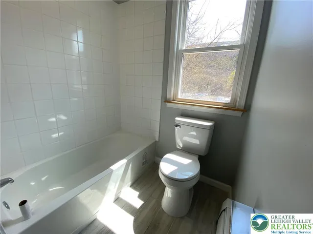 a bathroom with a toilet and a shower
