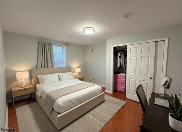 a bedroom with a bed and a couch