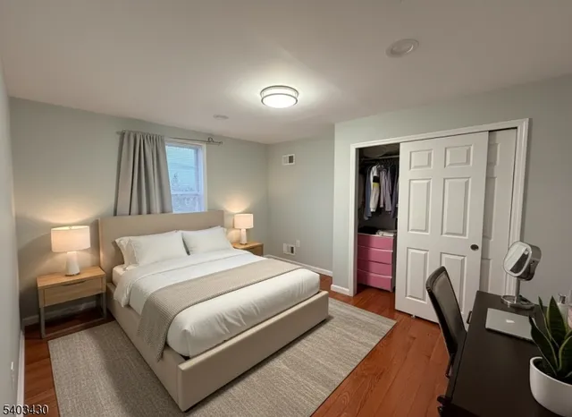 a bedroom with a bed and a couch