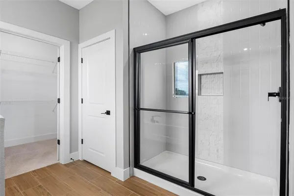 a bathroom with a glass shower door