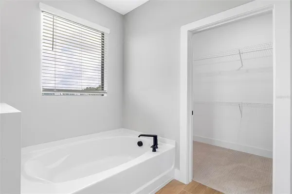 a white bath tub sitting next to a window