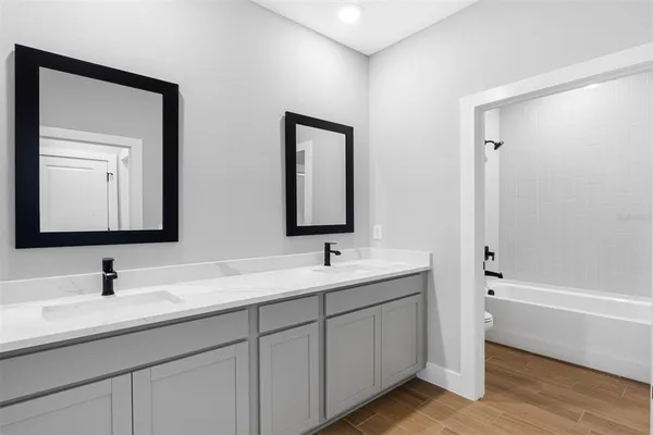 a bathroom with a double vanity sink and mirror