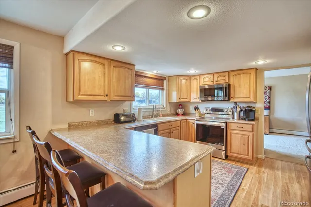 a kitchen with a stove a sink and a refrigerator