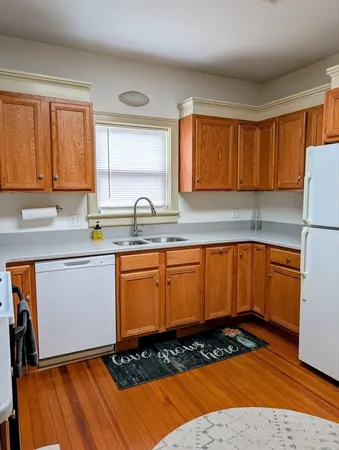 a kitchen with a refrigerator sink and cabinets