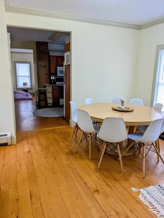 a view of a dining room with furniture and wooden floor