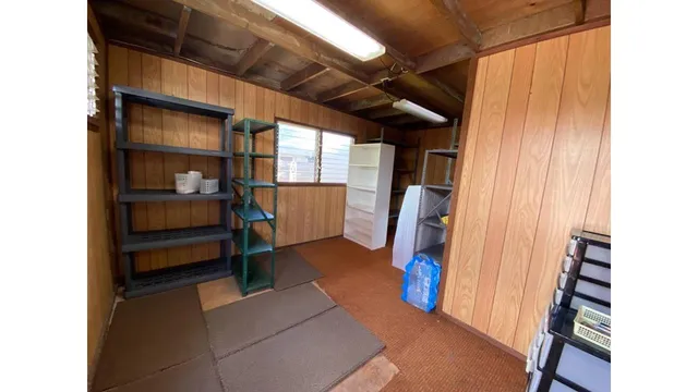 a view of a wooden fence and a fountain in the back yard