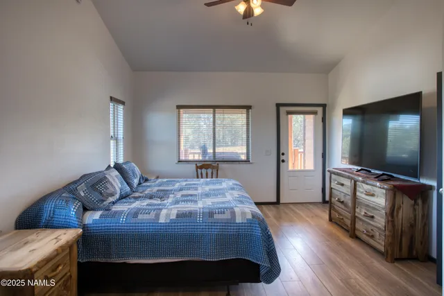 a bedroom with a bed and a flat screen tv