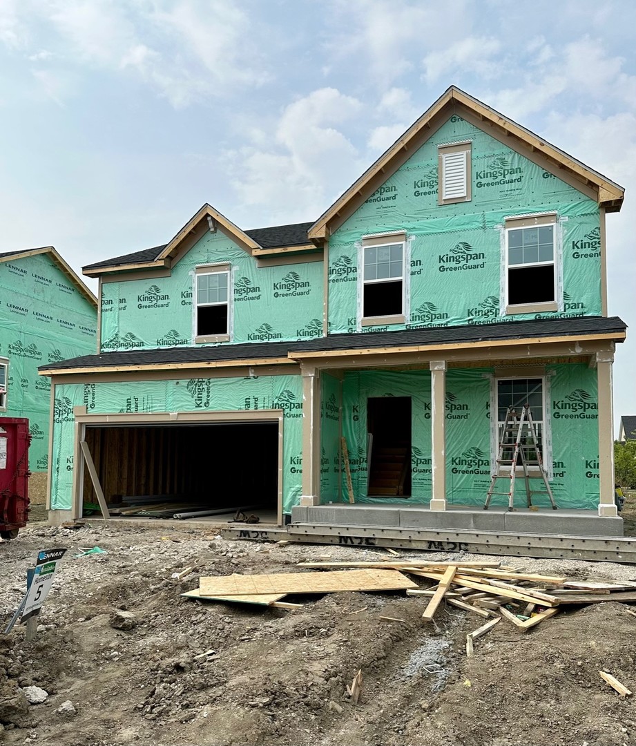 a view of a house with a balcony and yard