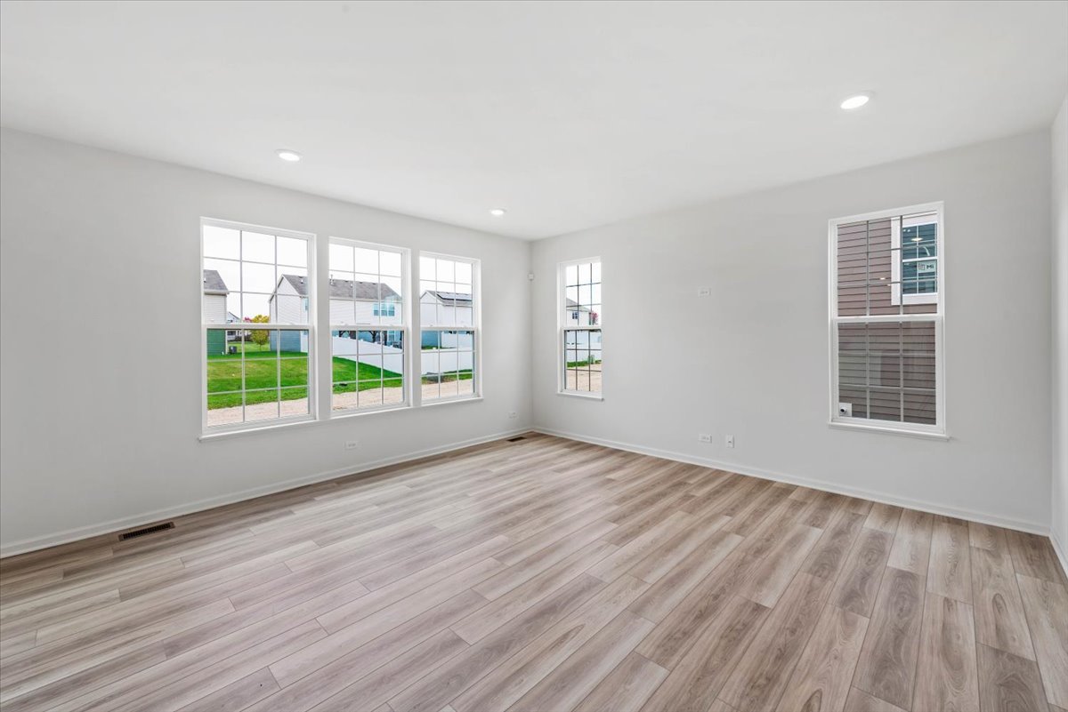 89 Hedgerow Drive Elgin, IL 60124 - Photo 13 of 51 a view of an empty room with wooden floor and a window