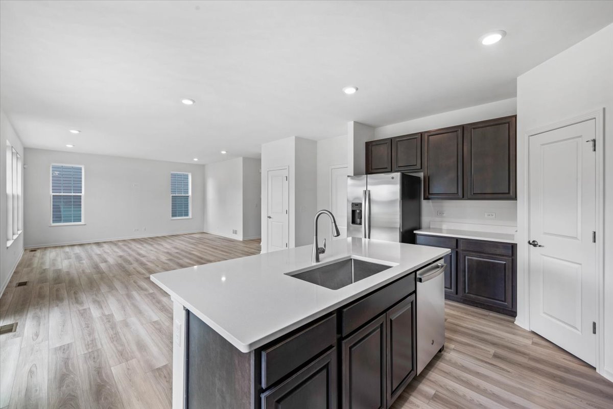 89 Hedgerow Drive Elgin, IL 60124 - Photo 18 of 51 a kitchen with kitchen island a sink appliances and cabinets