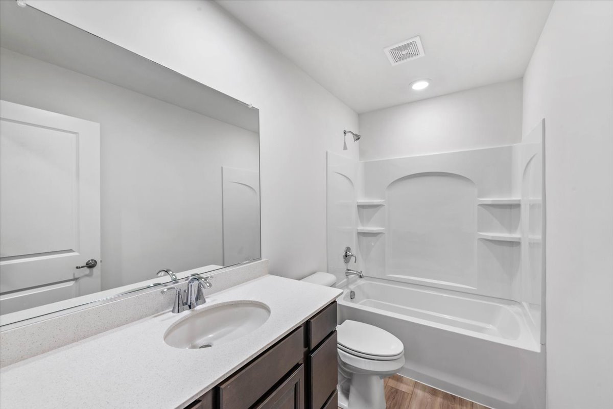 89 Hedgerow Drive Elgin, IL 60124 - Photo 23 of 51 a bathroom with a sink a toilet and a large mirror