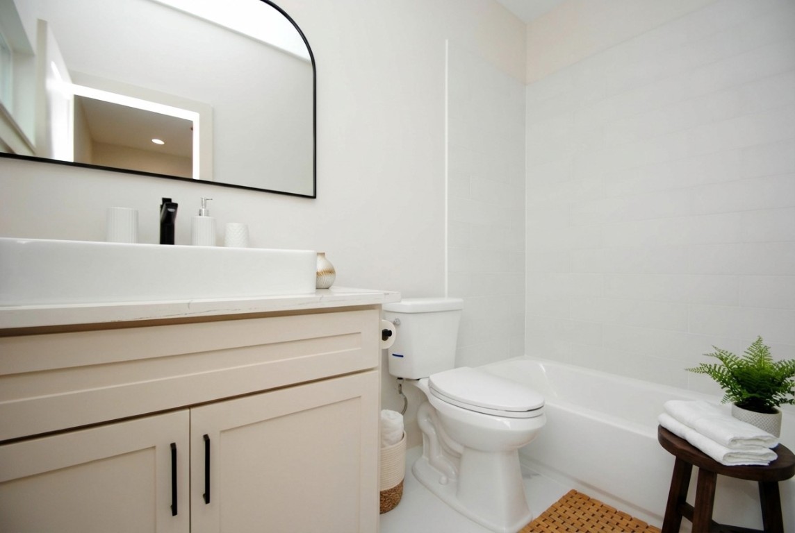 6310 Illinois Street, Unit A Houston, TX 77021 - Photo 19 of 22 a bathroom with a sink a toilet and a mirror