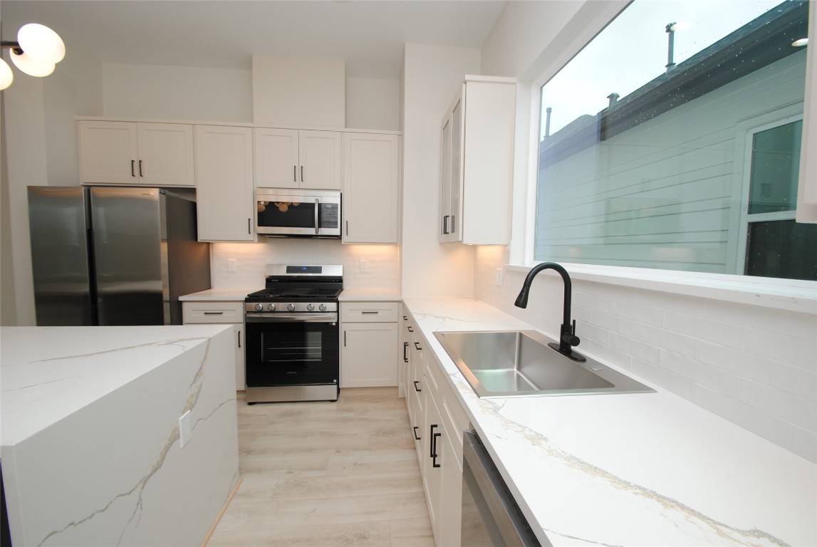 6310 Illinois Street, Unit A Houston, TX 77021 - Photo 8 of 22 a kitchen with a sink and a stove top oven