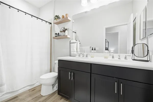 a bathroom with a sink toilet and shower
