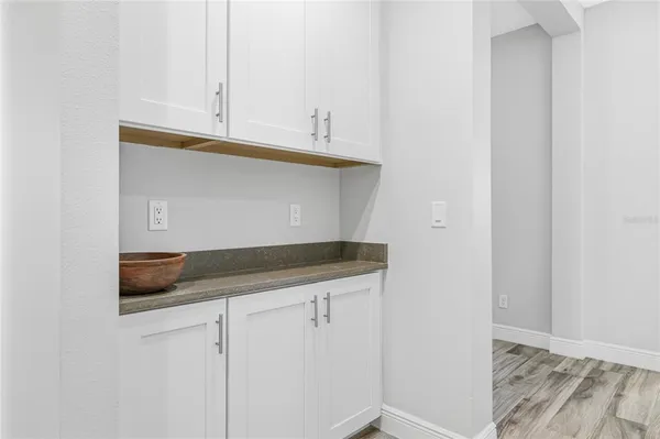 a kitchen with white cabinets and a sink