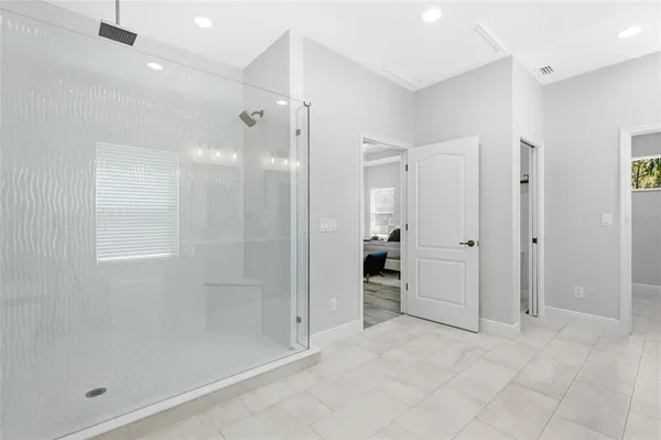 a bathroom with a shower and a glass door