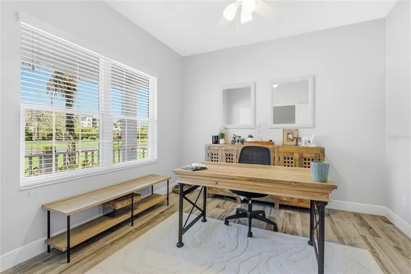 a view of a workspace with furniture and window