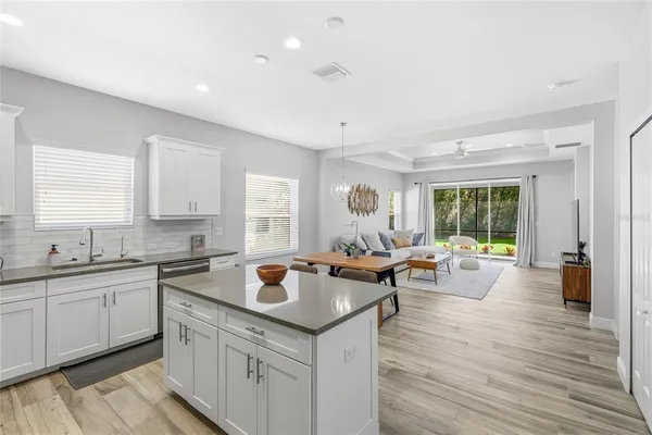 a kitchen with a sink and wooden floor
