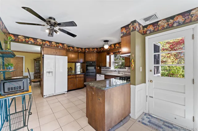 a view of a kitchen with furniture and a ceiling fan