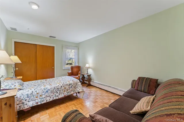 a bedroom with a bed and couch