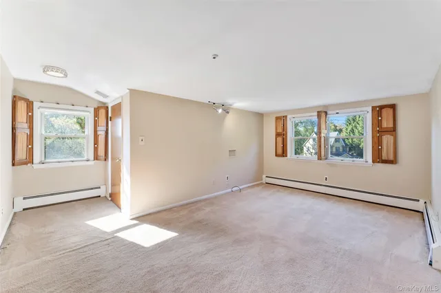 an empty room with windows and entrance