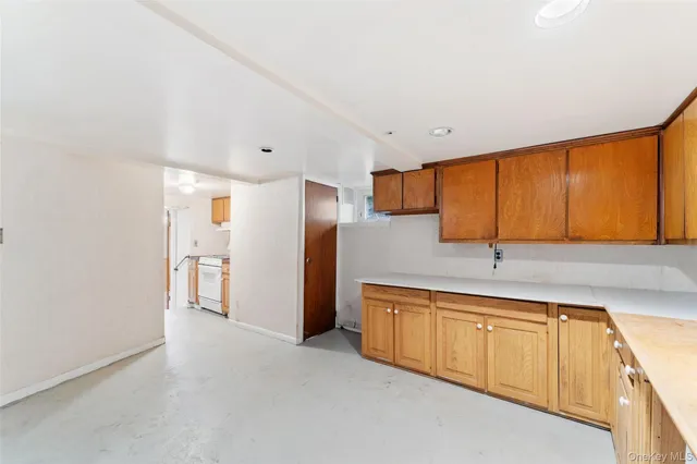 a view of a kitchen with stainless steel appliances granite countertop a refrigerator and a sink