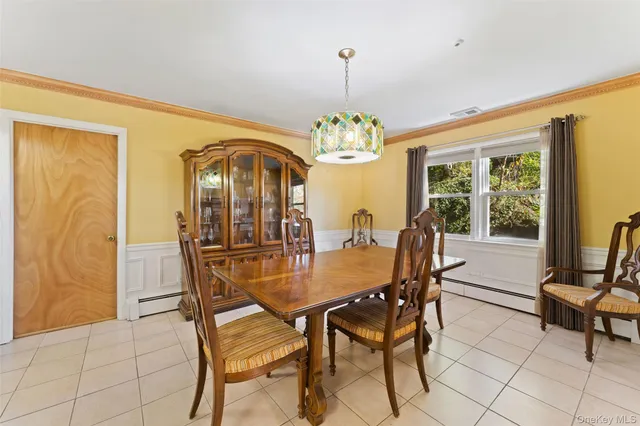 a view of a dining room with furniture and a chandelier