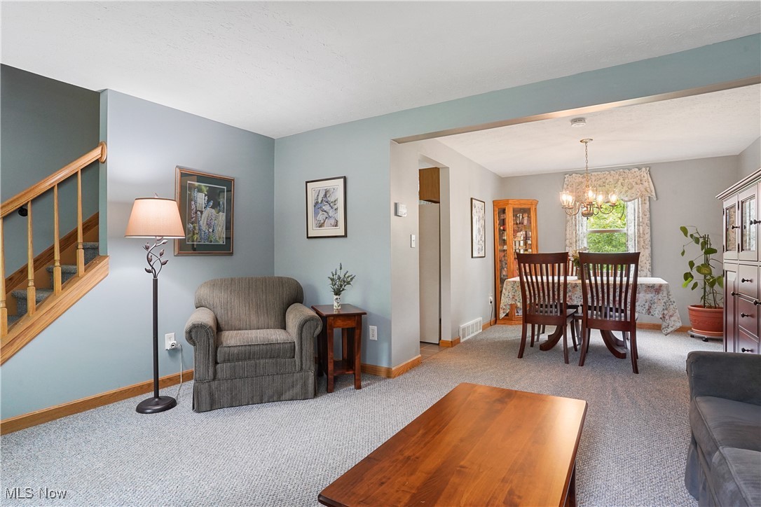 4190 Springdale Road Stow, OH 44224 - Photo 3 of 38 Carpeted living room with stairs, a chandelier, and baseboards