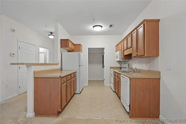 a kitchen with stainless steel appliances granite countertop a stove and a refrigerator